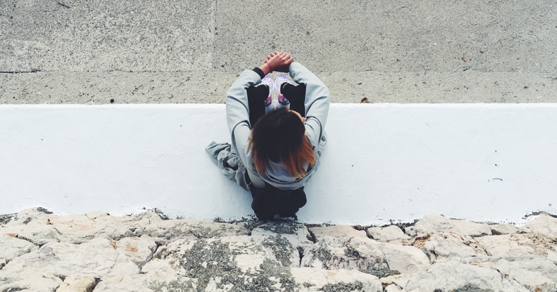 photo overlooking girl sitting from above